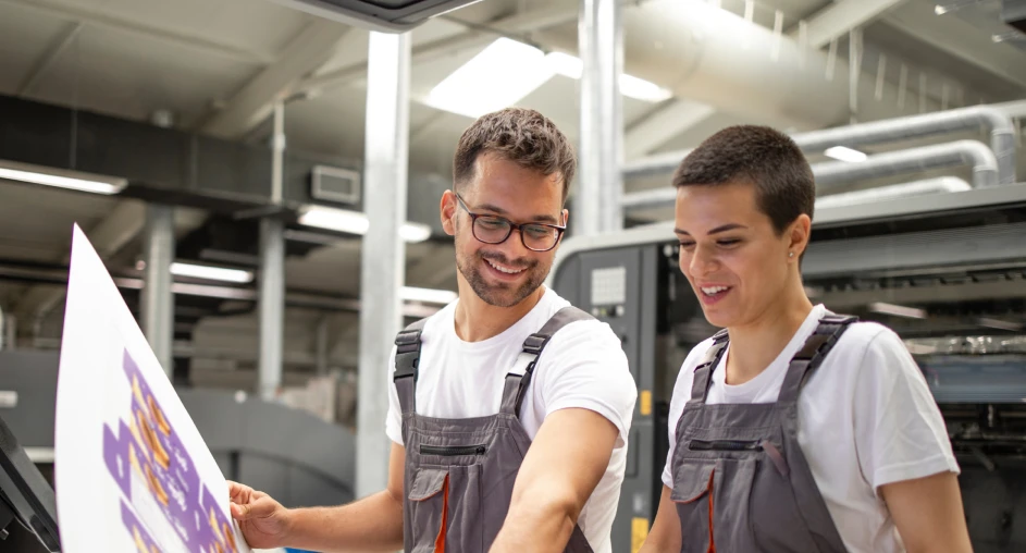 Printing technicians reviewing printed material in production facility