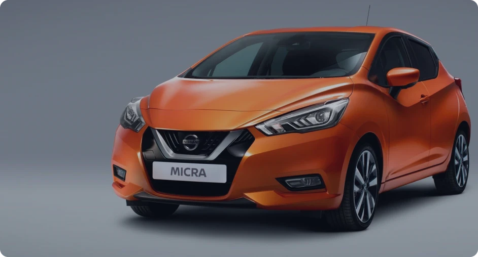 Orange Nissan Micra on a grey background